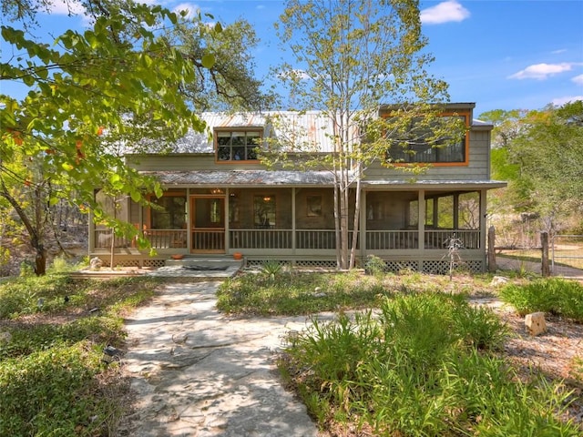 view of front of home featuring a sunroom