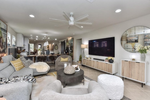 tiled living room with radiator heating unit and ceiling fan