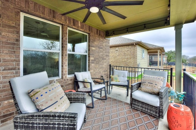 view of patio with ceiling fan and a balcony