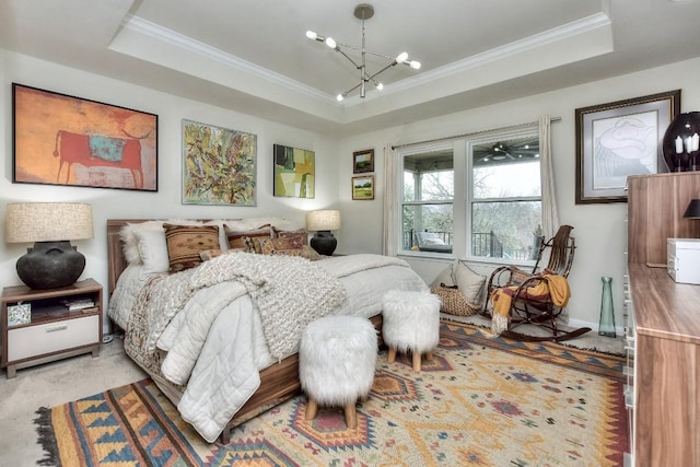 bedroom with a raised ceiling, ornamental molding, and an inviting chandelier