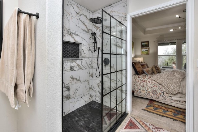 bathroom featuring crown molding and tiled shower