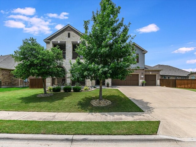 1533 Cresson Trl, Leander, TX 78641 - view of front facade with stone siding, driveway, an attached garage, and a balcony