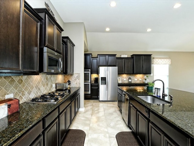 1533 Cresson Trl, Leander, TX 78641 - kitchen featuring appliances with stainless steel finishes, a sink, recessed lighting, tasteful backsplash, and dark stone countertops