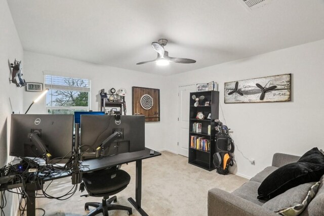 office area with ceiling fan and light carpet