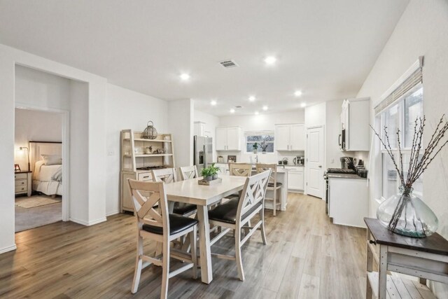 dining space with light hardwood / wood-style floors