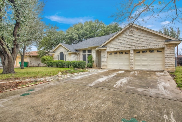 ranch-style house with a garage and a front lawn