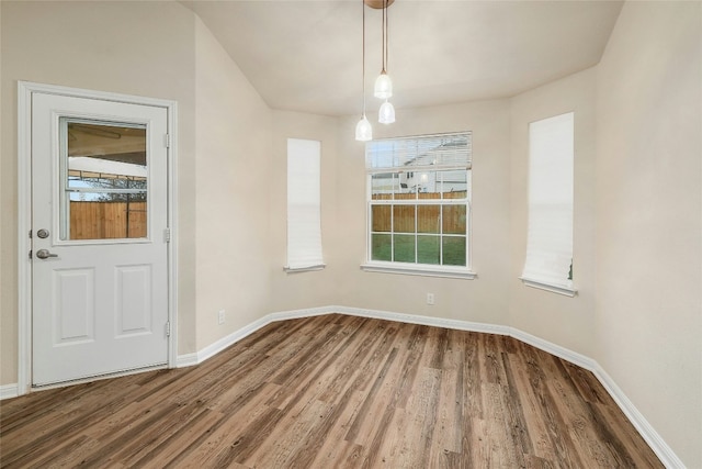 18825 Golden Eagle Way, Elgin, TX 78621 - unfurnished dining area featuring wood finished floors and baseboards
