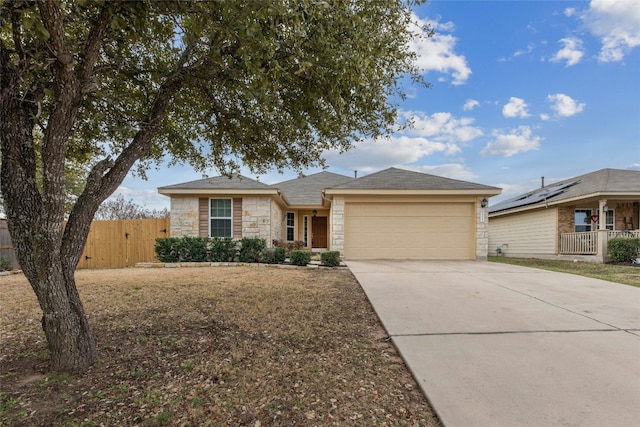 18825 Golden Eagle Way, Elgin, TX 78621 - ranch-style house with stone siding, an attached garage, and driveway