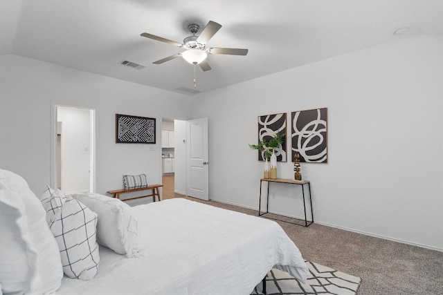 bedroom with visible vents, light carpet, vaulted ceiling, ceiling fan, and baseboards