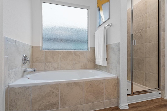 501 Bluejack Way, Hutto, TX 78634 - bathroom featuring a stall shower, a bath, and wood finished floors