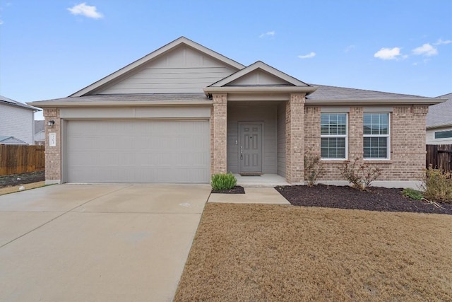 ranch-style home with driveway, brick siding, an attached garage, and fence