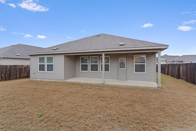 rear view of property with a patio area, a fenced backyard, and a lawn