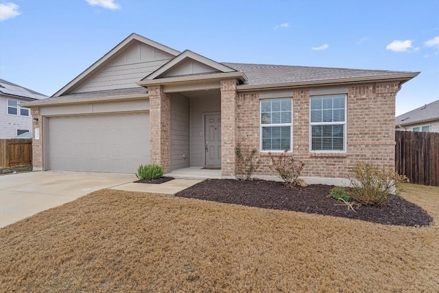 501 Bluejack Way, Hutto, TX 78634 - ranch-style home with brick siding, a garage, concrete driveway, and roof with shingles