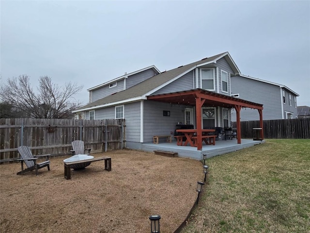 rear view of house featuring a patio area and a lawn