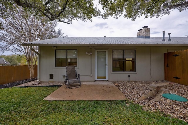 rear view of property with a lawn and a patio area