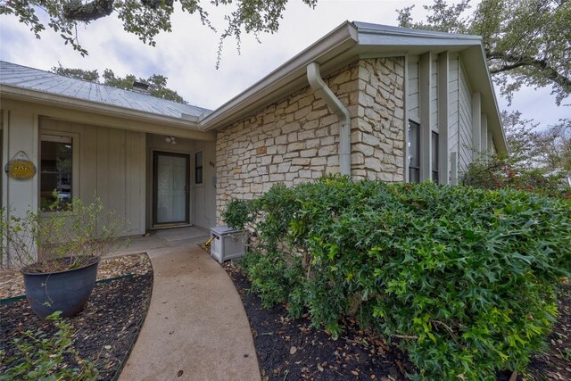 803 Castle Ridge Rd, Austin, TX 78746 - doorway to property featuring stone siding and a metal roof