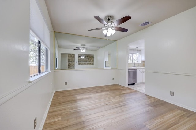 unfurnished room featuring sink and light wood-type flooring