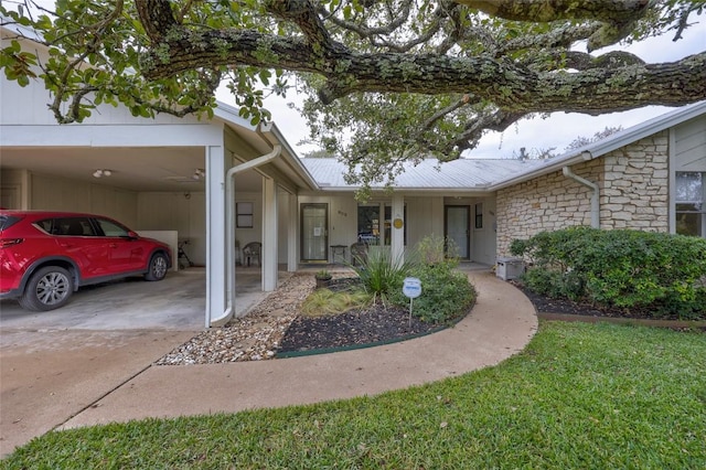 803 Castle Ridge Rd, Austin, TX 78746 - view of front facade with stone siding, a carport, and concrete driveway