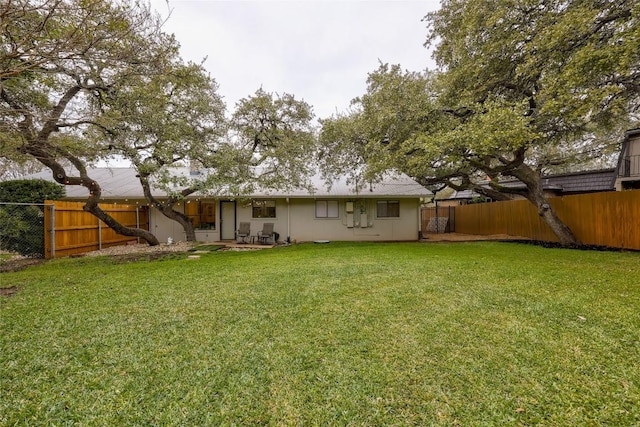 back of house featuring a lawn