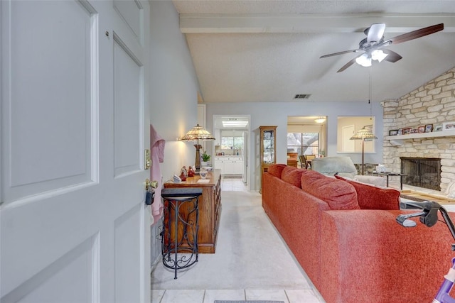 living room with vaulted ceiling with beams, a fireplace, and ceiling fan