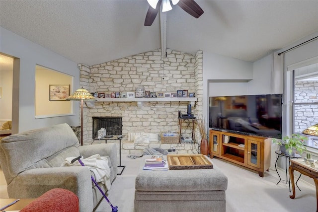 carpeted living room featuring ceiling fan, a fireplace, lofted ceiling with beams, and a textured ceiling