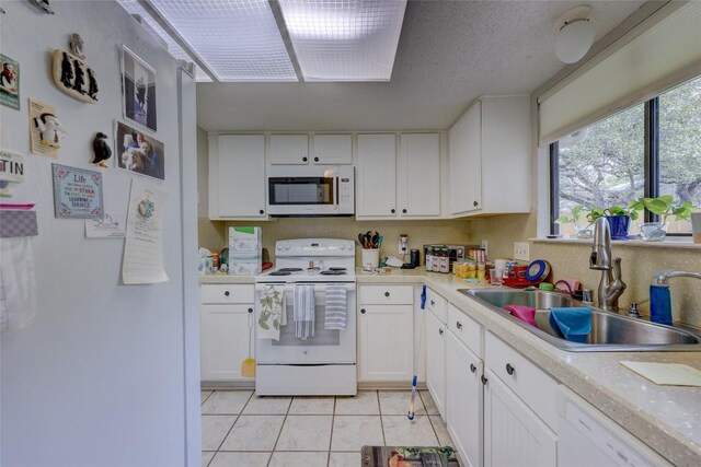 803 Castle Ridge Rd, Austin, TX 78746 - kitchen with white appliances, light countertops, and white cabinetry