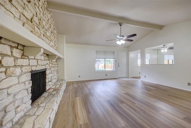 unfurnished living room featuring ceiling fan, vaulted ceiling with beams, hardwood / wood-style floors, and a fireplace