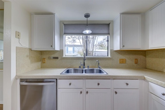 kitchen with white cabinetry, stainless steel dishwasher, sink, and pendant lighting