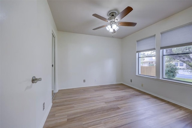 unfurnished room featuring ceiling fan and light wood-type flooring