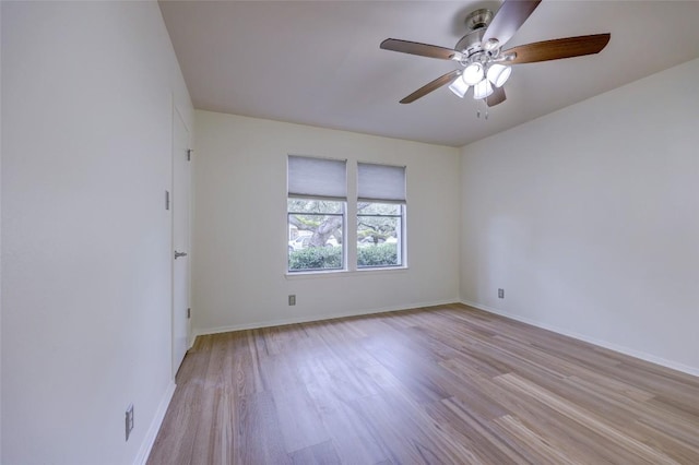 empty room featuring ceiling fan and light hardwood / wood-style flooring