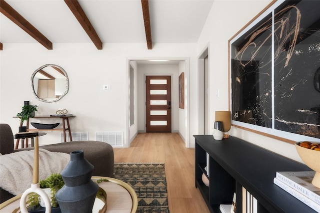 foyer with beamed ceiling and light hardwood / wood-style floors