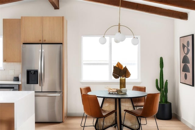 kitchen featuring pendant lighting, decorative backsplash, stainless steel fridge, and beam ceiling