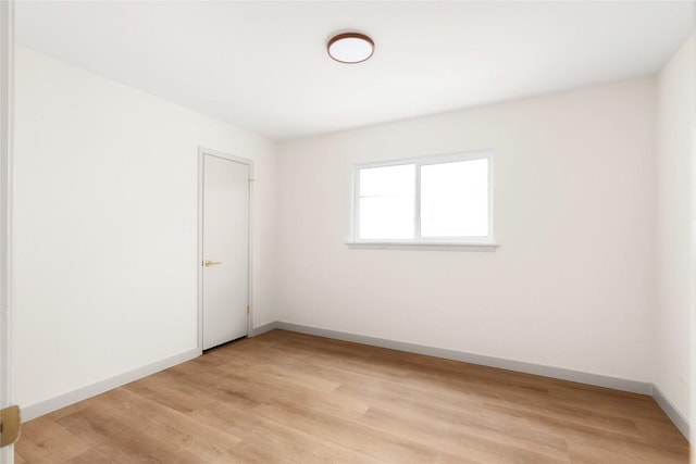 spare room with light hardwood / wood-style flooring