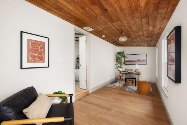 living area with hardwood / wood-style flooring and wooden ceiling