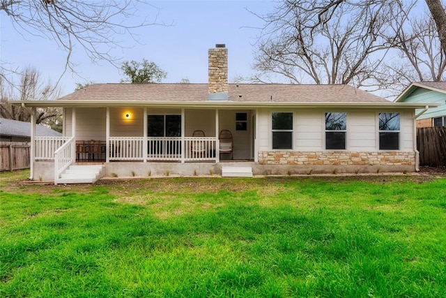 back of house featuring a porch and a lawn