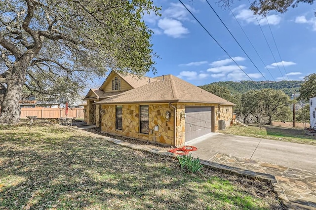 view of property exterior featuring a garage, a yard, and central air condition unit