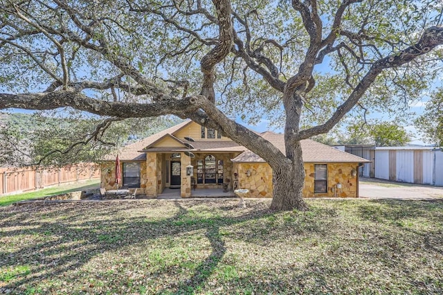 view of front of house with a patio and a front lawn