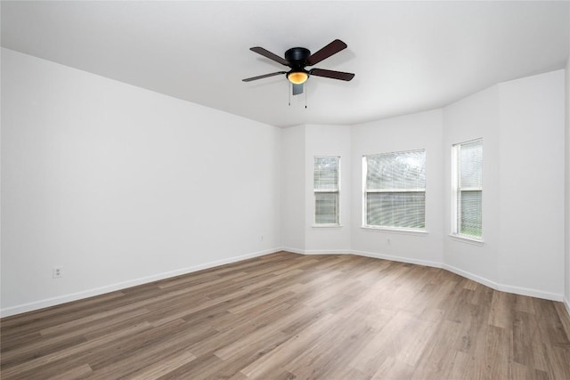 empty room with ceiling fan and light wood-type flooring