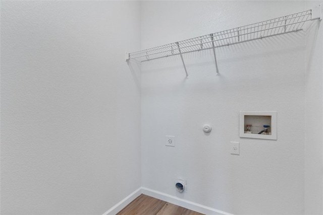 washroom with hardwood / wood-style flooring, gas dryer hookup, hookup for an electric dryer, and hookup for a washing machine