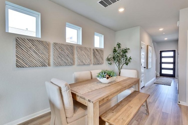 dining space with light hardwood / wood-style floors