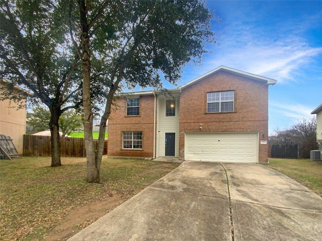 traditional-style home featuring a front yard, fence, driveway, and an attached garage