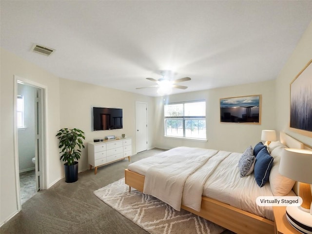 carpeted bedroom featuring a ceiling fan, visible vents, connected bathroom, and baseboards