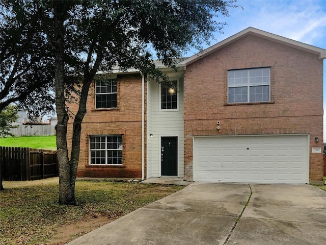 traditional-style home with an attached garage, fence, concrete driveway, and brick siding