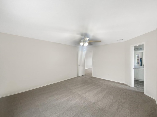 empty room with ceiling fan, carpet flooring, and baseboards