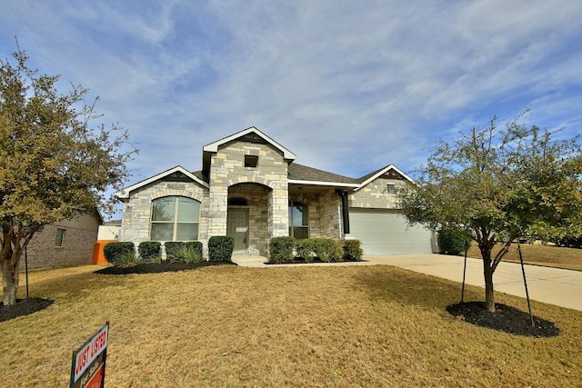 view of front of house with a garage and a front yard