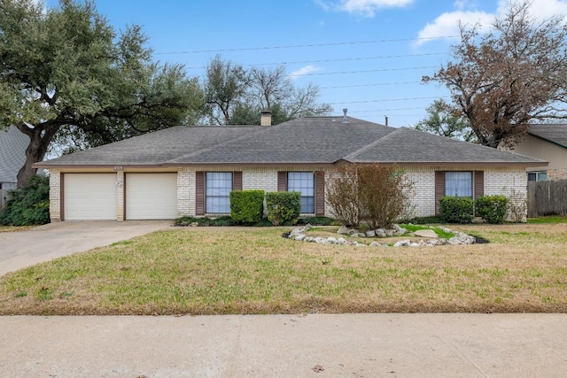 ranch-style home featuring a garage and a front lawn