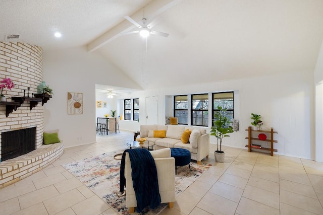 tiled living room featuring ceiling fan, a fireplace, high vaulted ceiling, and beamed ceiling