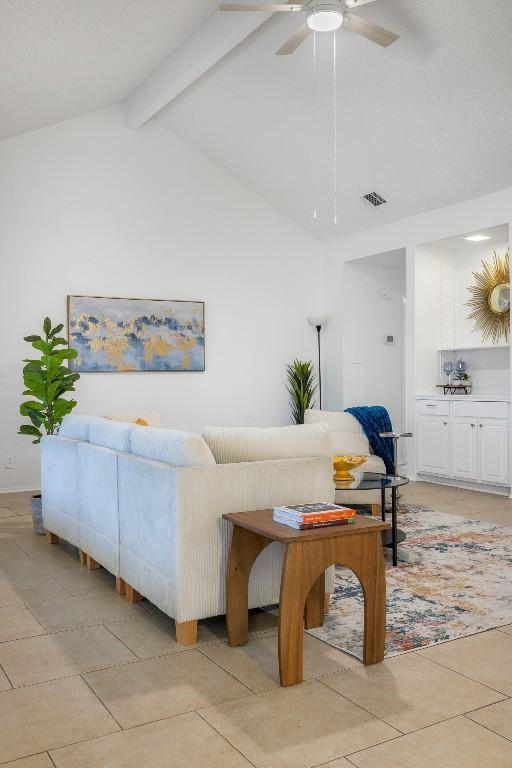 tiled living room with lofted ceiling with beams and ceiling fan