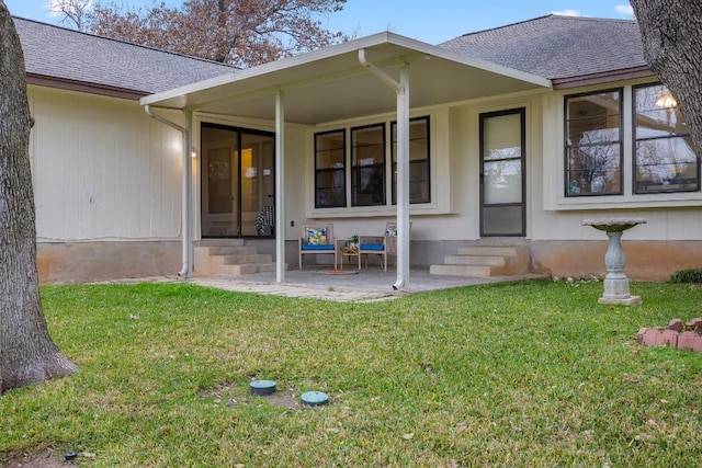 doorway to property with a yard