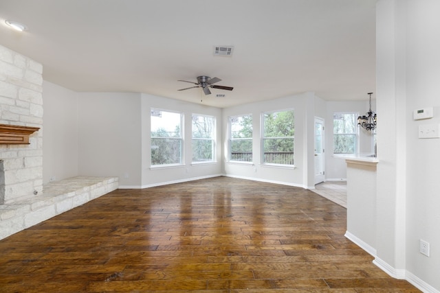 2901 Cashell Wood Dr, Cedar Park, TX 78613 - unfurnished living room with a ceiling fan, dark wood-type flooring, a chandelier, and a fireplace